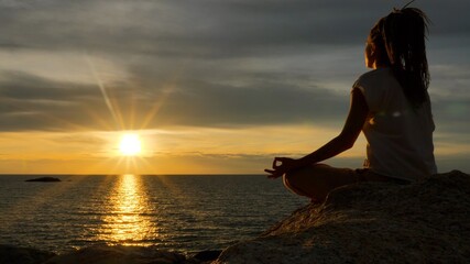 Serenity and yoga practicing by the sea in twilight sunset time, meditation