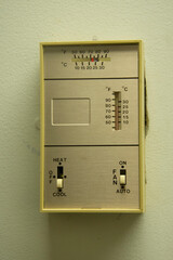 Close up of a manual wall mounted thermostat.