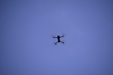 Fototapeta na wymiar Drone in flight against a blue sky