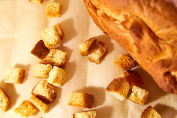 Square toasted pieces of homemade delicious rusk, hardtack, Dryasdust, zwieback and bread on a white tablecloth.
