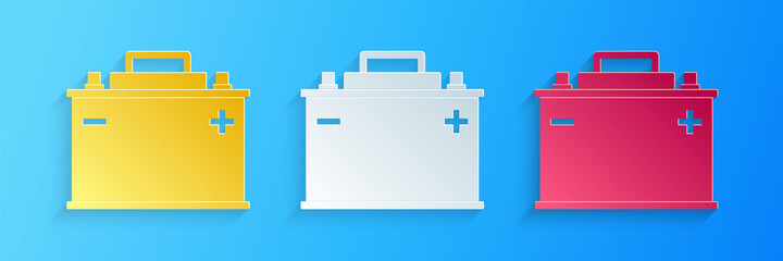 Paper cut Car battery icon isolated on blue background. Accumulator battery energy power and electricity accumulator battery. Paper art style. Vector.