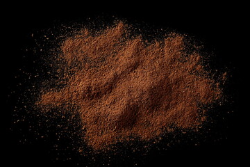 Fototapeta na wymiar Cinnamon powder pile isolated on black background, top view