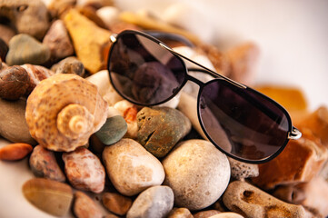 Sunglasses with plastic frame on stone background