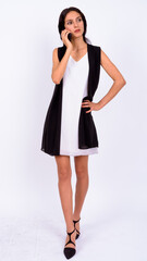 Portrait of young beautiful businesswoman talking on the phone