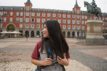 young Asian woman visiting Europe in holidays as backpacker tourist - happy and attractive Chinese...