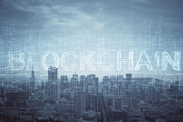 Double exposure of crypto currency theme hologram drawing and city veiw background. Concept of blockchain and bitcoin.