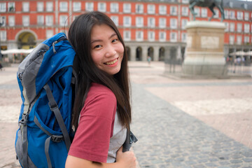 young Asian woman visiting Europe in holidays as backpacker tourist - happy and attractive Korean...