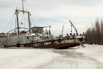 Frozen ship graveyard with two rusty industrial ships