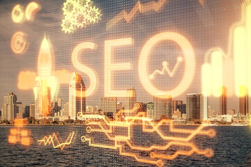 SEO hologram on city view with skyscrapers background double exposure. Search optimization concept.