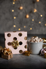 Mug for mockup near christmas tree and gift boxes.