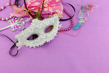 A festive,Beautiful mardi gras or carnival mask on beautiful colorful paper background.