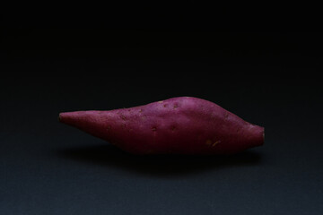 Sweet potato on black background.