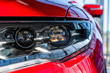 Close-up of the front light of a modern car. Exterior details.