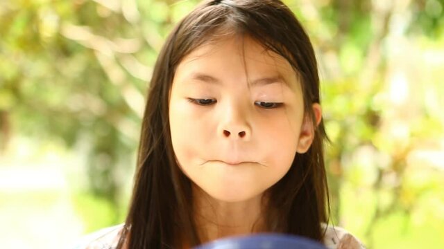 Thai  little girl  makeup  her  face   , out  door  Chiangmai  Thailand