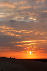 Fototapeta na wymiar Beautiful sunrise with dramatic cloudscape at White Sand Dunes in Mui Ne, Vietnam