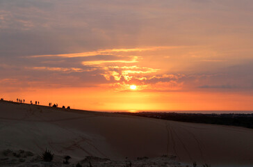 Beautiful sunrise with dramatic cloudscape at White Sand Dunes in Mui Ne, Vietnam