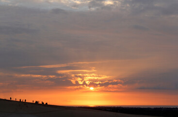 Beautiful sunrise with dramatic cloudscape at White Sand Dunes in Mui Ne, Vietnam