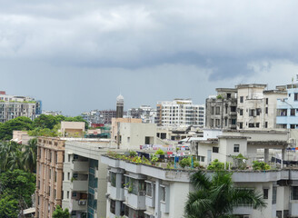 Townscape. Ancient architecture in the city of Dhaka, Bangladesh. View of the buildings, structures, and rooftops of the village under a dramatic cloudy sky.