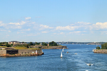 entrance to helsinki harbour with boats and lighthouse