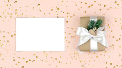 Mock up greeting holiday composition in trendy pastel  color. Empty paper blank, gift box on pink background with golden confetti. Christmas, New year,  Mothers day or wedding concept.