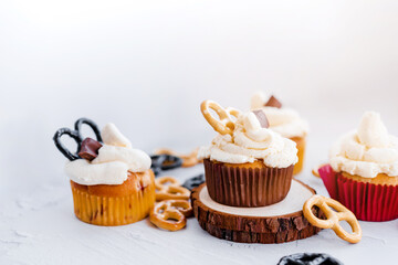 Festive delicious cupcakes with chocolate, strawberries and pretzels painted on a white background
