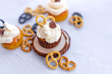 Festive delicious cupcakes with chocolate, strawberries and pretzels painted on a white background