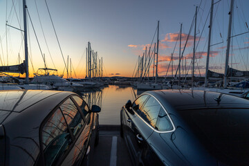 Luxury cars and yachts in a port at sunset - Powered by Adobe