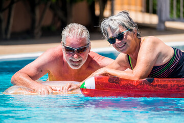 Happy retired senior caucasian couple enjoy together the summer with an active lifestyle at the...