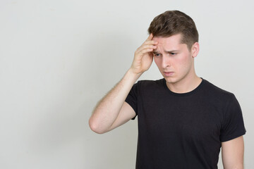 Portrait of young handsome man against white background