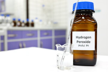 Selective focus of hydrogen peroxide solution in brown amber bottle. Blur laboratory background...