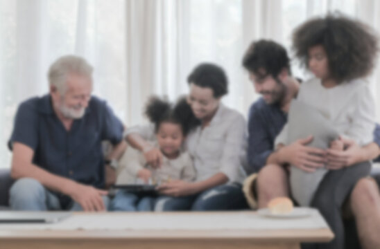 Soft and blur photography of multi ethnic people spending time together with happy smiling face in cozy living room warmth house. Family relationship, kids mentoring background concept.