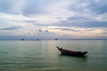 Naklejka na ściany i meble long tail boat at sunset on a beach in Koh Tao, Thailand