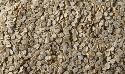 Oat flakes, cereal for breakfast surface background and texture