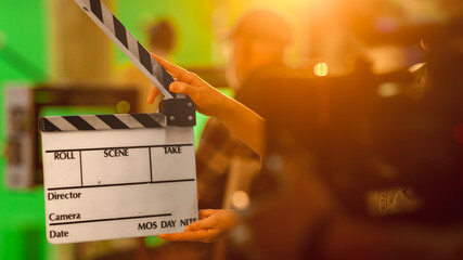 Close up Shot On Film Studio Set Young Camera Assistant Holds Empty Clapperboard. In the Background...