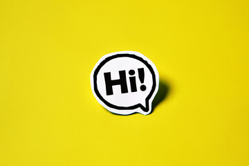 Hi speech bubble on white paper isolated on yellow paper background with drop shadow. COPY SPACE.