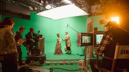 On Set: Famous Female Director Controls Cameraman Shooting Green Screen Scene with Two Actors Talented Wearing Renaissance Clothes Talking. Crew Shooting Period Costume Drama Movie. - obrazy, fototapety, plakaty