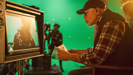 Director Looks at Display and Compares to Storyboard while Shooting Blockbuster Movie. Green Screen...