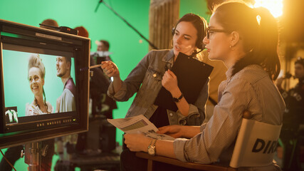 Famous Talented Female Director in Chair Looks at Display talks with Assistant, Shooting...