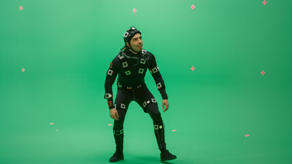 Actor Wearing Motion Caption Suit and Head Rig acts as an Animal or a Monster for CGI Green Screen Scene. Big Budget Filmmaking On Film Studio Set Shooting Blockbuster Movie with Chroma Key