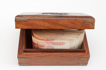 Russian banknotes of five thousand rubles in large quantities in a wooden box