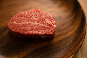 Fillet steak on wooden plate