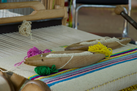 Wooden handloom for creating a handwoven woollen fabric