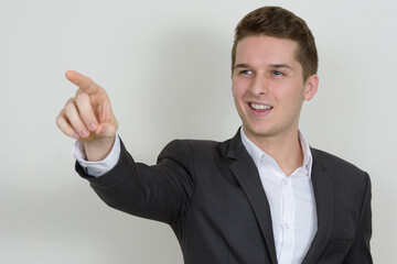 Portrait of happy young handsome businessman in suit