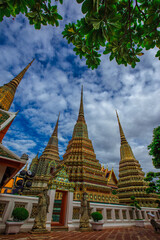 Fototapeta premium background of important religious attractions in Bangkok (Wat Phra Chetuphon (Wat Pho - reclining Buddha), a large pagoda and beautiful sculptural art give future generations to explore its history