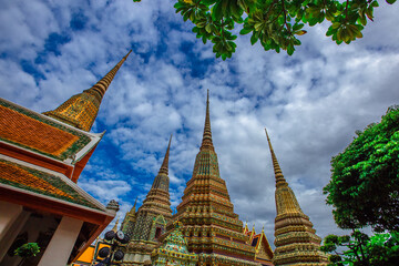 Fototapeta premium background of important religious attractions in Bangkok (Wat Phra Chetuphon (Wat Pho - reclining Buddha), a large pagoda and beautiful sculptural art give future generations to explore its history