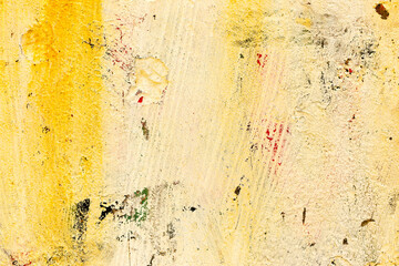 Great colorful background or texture. Abstract concrete is aged with cracks, scratches and remnants of old paint in different shades. Rough concrete surface