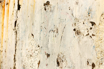 Background concrete wall, traces of weathering, worn wall damaged paint old paint. Remains of old paint on the painted concrete surface. Grungy concrete surface.