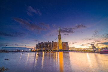 Fototapeta premium Sunset at Landmark 81 is a super tall skyscraper in center Ho Chi Minh City, Vietnam and Saigon bridge with development buildings, energy power infrastructure.