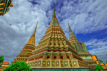Fototapeta premium background of important religious attractions in Bangkok (Wat Phra Chetuphon (Wat Pho - reclining Buddha), a large pagoda and beautiful sculptural art give future generations to explore its history
