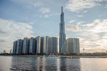 Fototapeta premium Beautiful blue sky view at Landmark 81 is a super tall skyscraper in center Ho Chi Minh City, Vietnam and Saigon bridge with development buildings, energy power infrastructure.